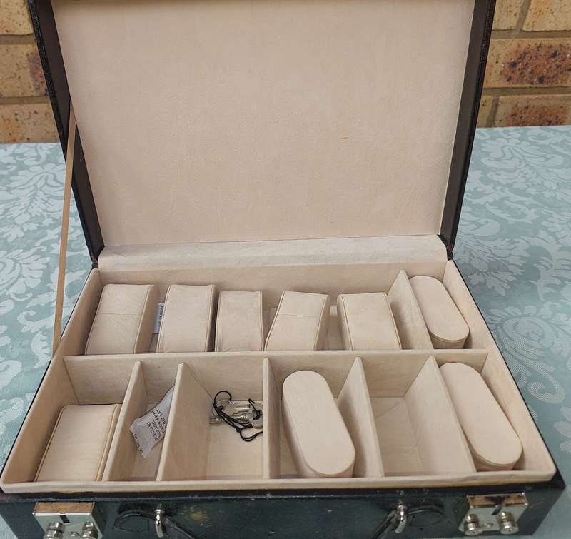 A BLACK LEATHER CASE FOR THE AVID WATCH COLLECTOR WITH KEYS  THE CASE HAS A FEW SCRATCHES SOLD AS IS