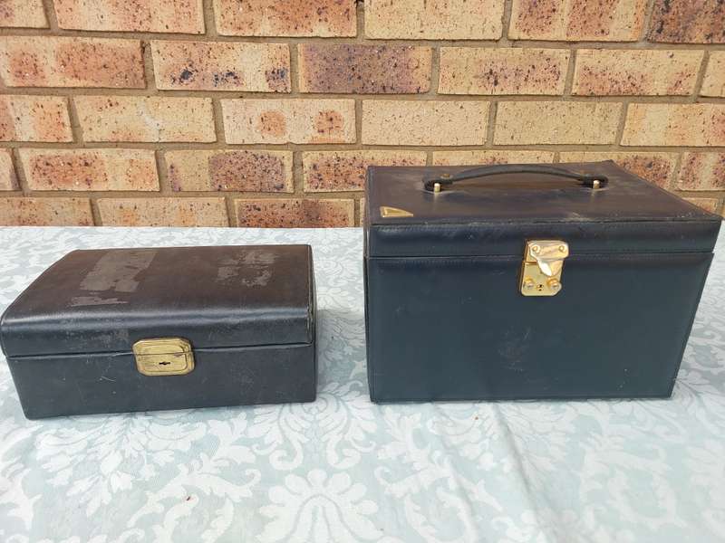 TWO LEATHER FAUX JEWELRY BOXES NEEDS TO BE CLEANED IN RELATIVE GOOD CONDITION SOLD AS IS