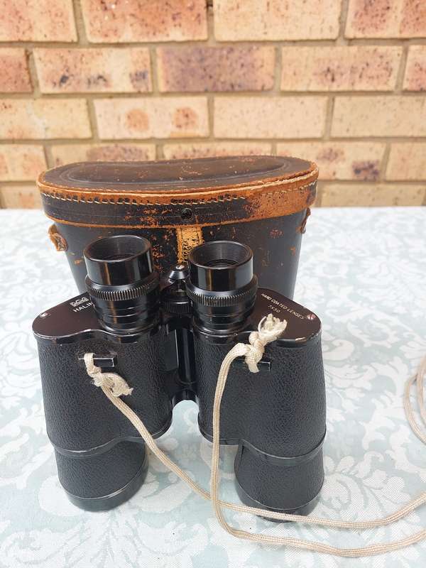A VINTAGE HALINA HARD COATED LENSE 7X50 BINOCULARS SOLD AS IS