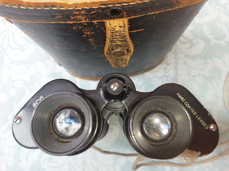 A VINTAGE HALINA HARD COATED LENSE 7X50 BINOCULARS SOLD AS IS