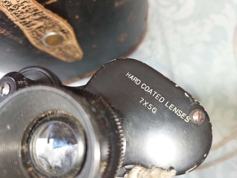 A VINTAGE HALINA HARD COATED LENSE 7X50 BINOCULARS SOLD AS IS