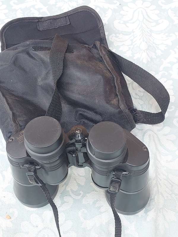 A TASCO 10X50MM BINOCULARS SOLD AS IS