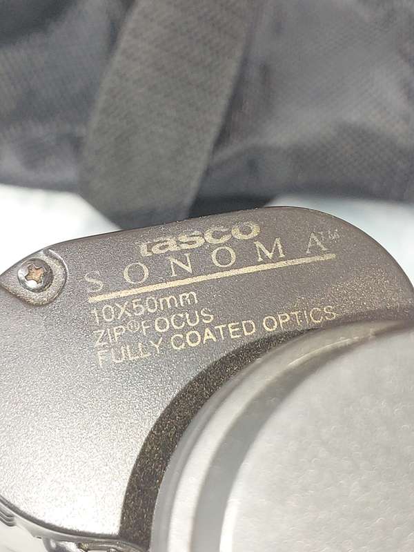 A TASCO 10X50MM BINOCULARS SOLD AS IS