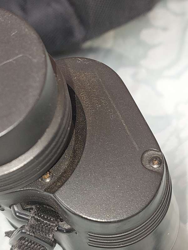 A TASCO 10X50MM BINOCULARS SOLD AS IS