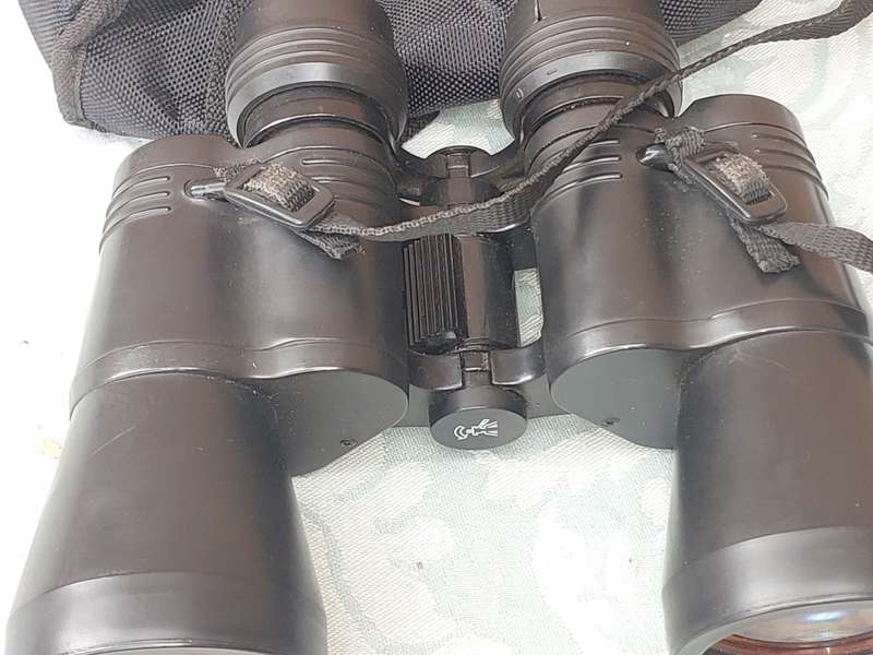 A TASCO 10X50MM BINOCULARS SOLD AS IS