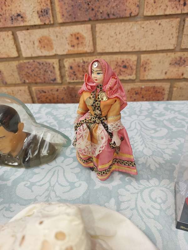 A VINTAGE COLLECTION OF DOLLS AND FIGURINES SOLD AS IS