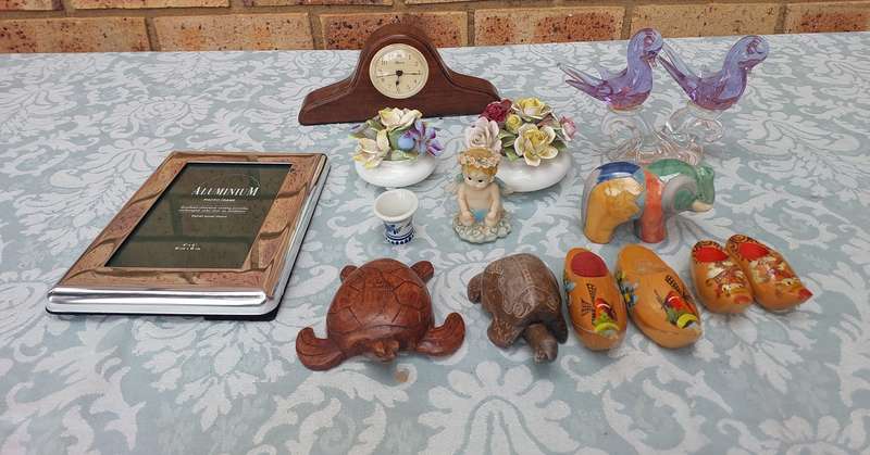 A COLLECTION OF FIGURINES AND A SILVER PLATED PHOTO FRAME SOLD AS IS