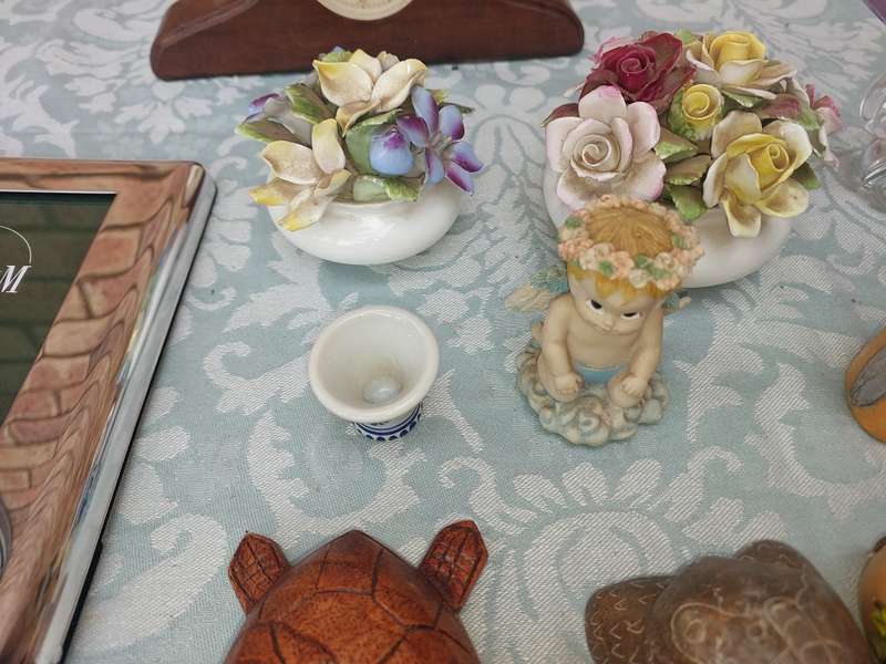 A COLLECTION OF FIGURINES AND A SILVER PLATED PHOTO FRAME SOLD AS IS