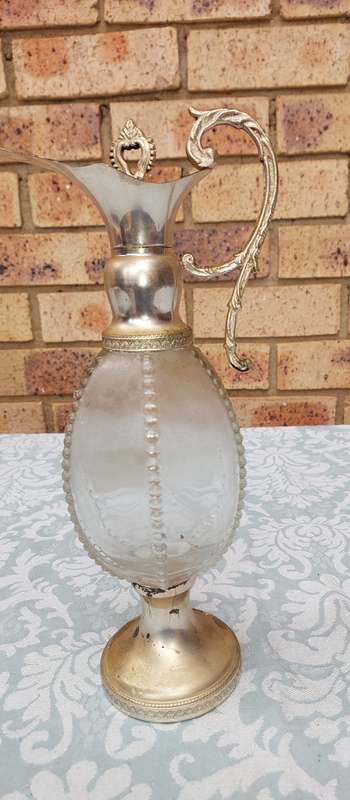 AN ORNATE ART DECOR OIL JUG SOLD AS IS