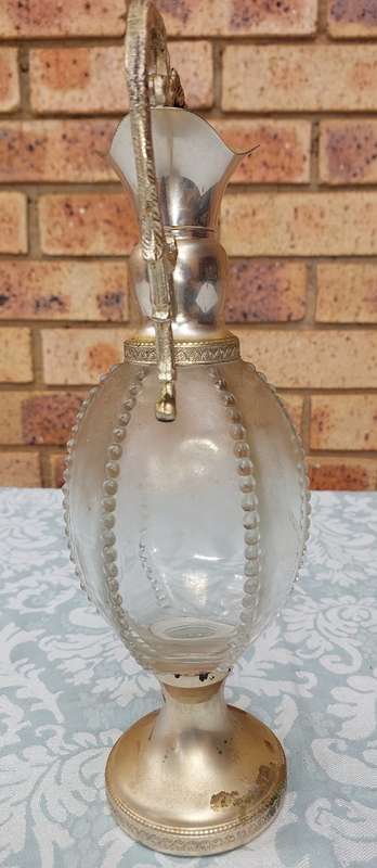 AN ORNATE ART DECOR OIL JUG SOLD AS IS