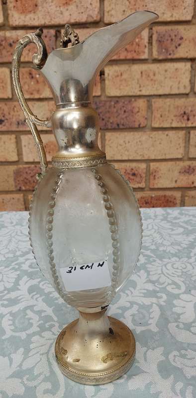 AN ORNATE ART DECOR OIL JUG SOLD AS IS