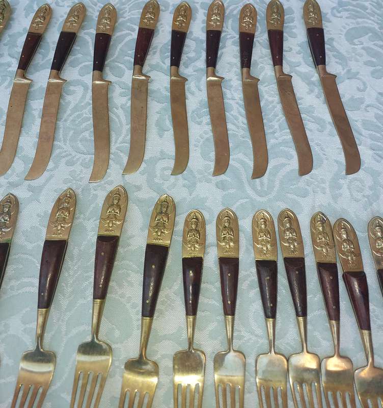 A 72 PIECE SIAM BUDDHA  NICKEL BRONZE CUTLERY SET MADE IN THAILAND SOLD AS IS