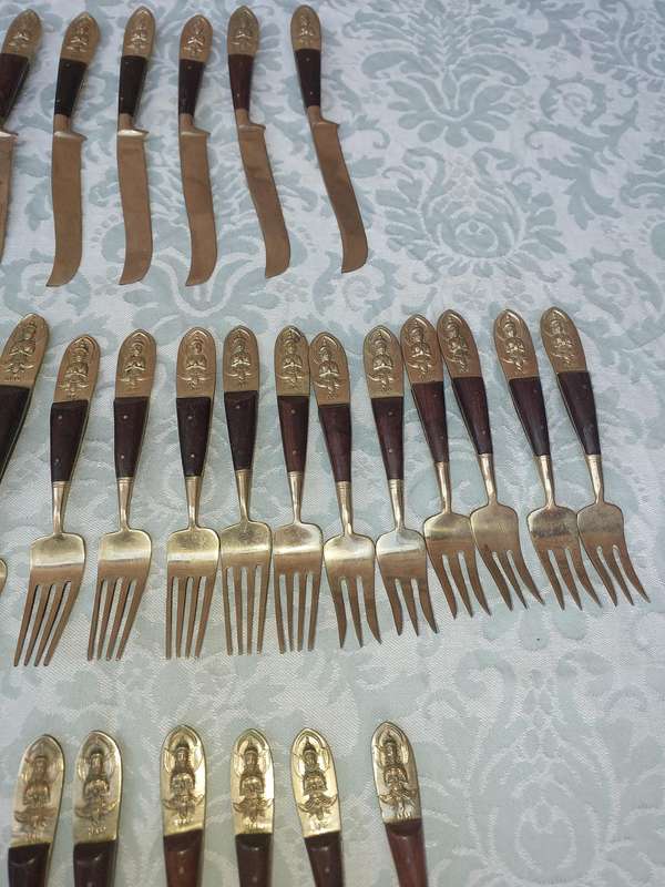 A 72 PIECE SIAM BUDDHA  NICKEL BRONZE CUTLERY SET MADE IN THAILAND SOLD AS IS