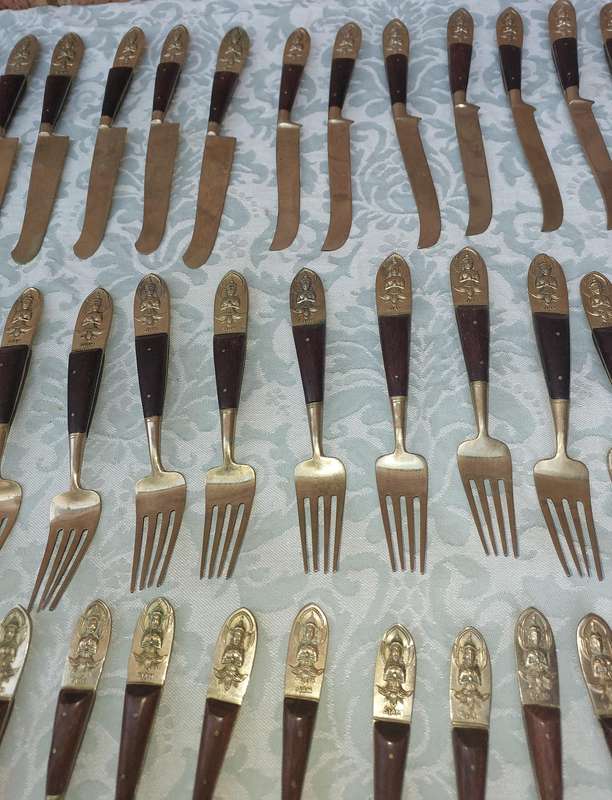 A 72 PIECE SIAM BUDDHA  NICKEL BRONZE CUTLERY SET MADE IN THAILAND SOLD AS IS