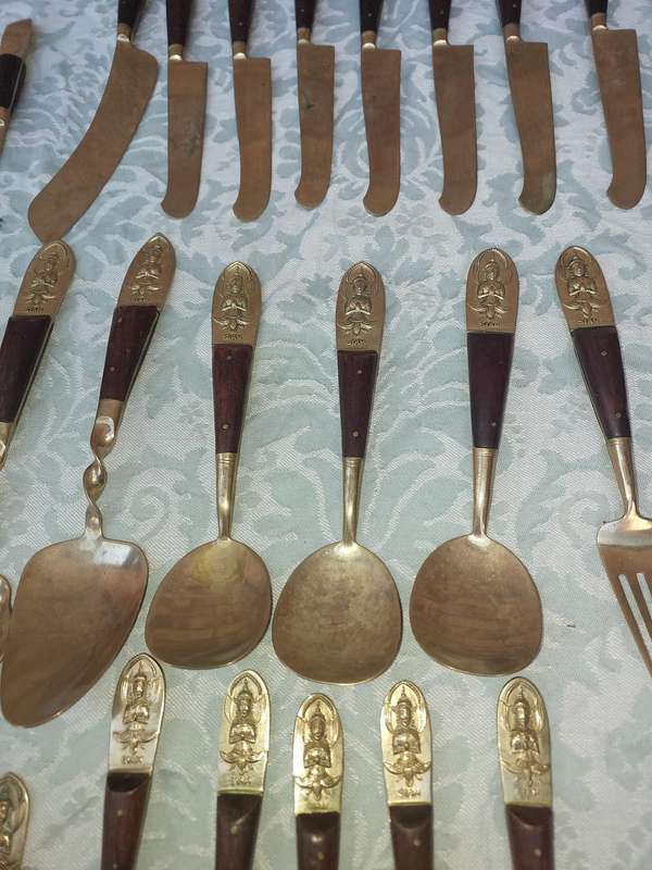 A 72 PIECE SIAM BUDDHA  NICKEL BRONZE CUTLERY SET MADE IN THAILAND SOLD AS IS
