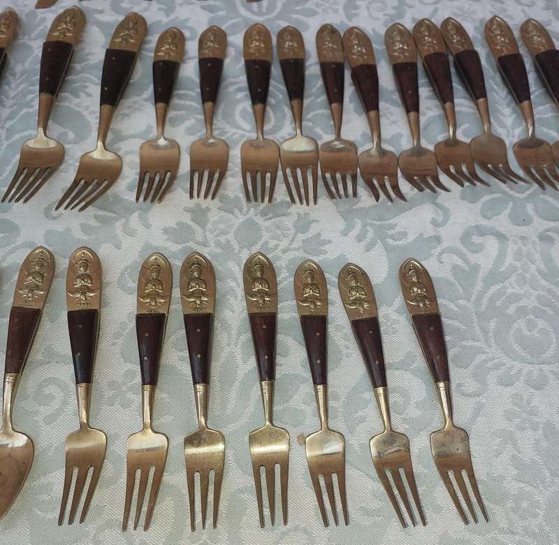 A 72 PIECE SIAM BUDDHA  NICKEL BRONZE CUTLERY SET MADE IN THAILAND SOLD AS IS