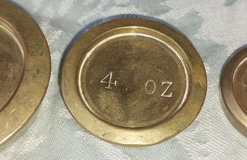 A VINTAGE CAST IRON AND BRONZE SCALE WITH THE BRONZE WEIGHTS SOLD AS IS