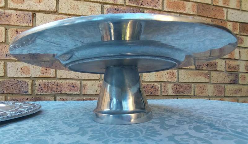 TWO ART DECOR ALLOY PEWTHAL  HAND MADE IN INDIA PLATTERS ,ONE IS FOOTED ,SOLD AS IS