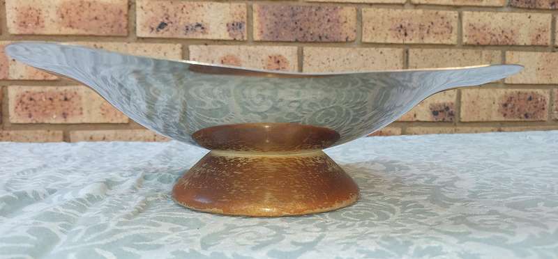 A VINTAGE ART DECOR SERVING PLATTER STAINLESS STEEL WITH A WOODEN FOOT SOLD AS IS