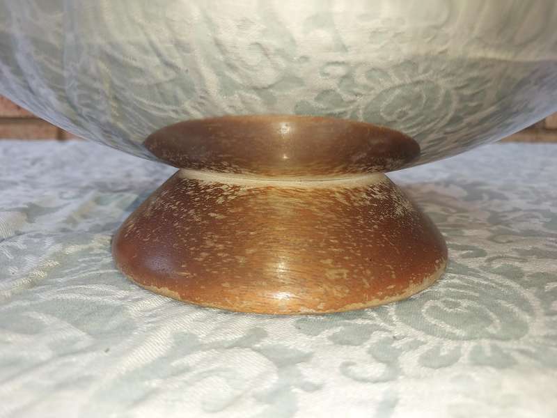 A VINTAGE ART DECOR SERVING PLATTER STAINLESS STEEL WITH A WOODEN FOOT SOLD AS IS