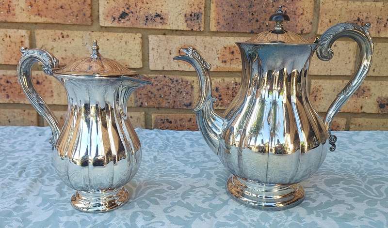 TWO VINTAGE SILVER PLATED TEA JUGS VICTORIAN SOLD AS IS