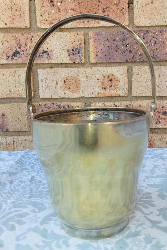 A VINTAGE SILVER PLATED ICE BUCKET SOLD AS IS