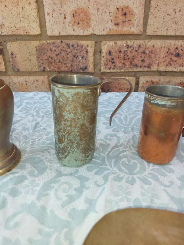 A COLLECTION OF ART DECOR BRASS AND COPPER UTENSILS SOLD AS IS