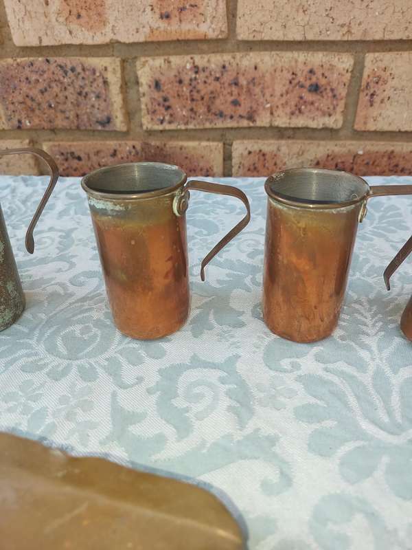 A COLLECTION OF ART DECOR BRASS AND COPPER UTENSILS SOLD AS IS