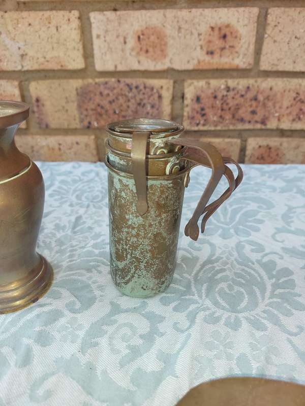 A COLLECTION OF ART DECOR BRASS AND COPPER UTENSILS SOLD AS IS