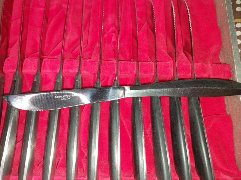 A VINTAGE 24 PIECE SAVOY STAINLESS STEEL STEAK KNIFE AND FORK SET IN ITS ORIGINAL BOX SOLD AS IS