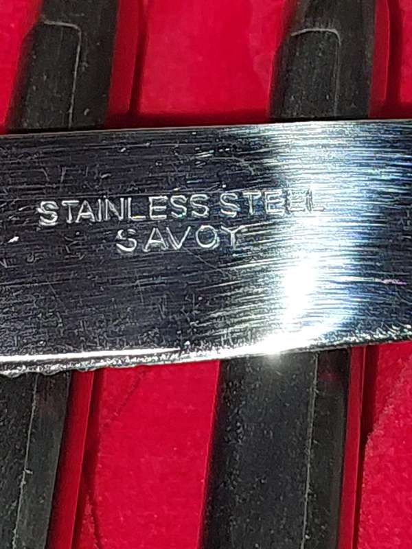 A VINTAGE 24 PIECE SAVOY STAINLESS STEEL STEAK KNIFE AND FORK SET IN ITS ORIGINAL BOX SOLD AS IS