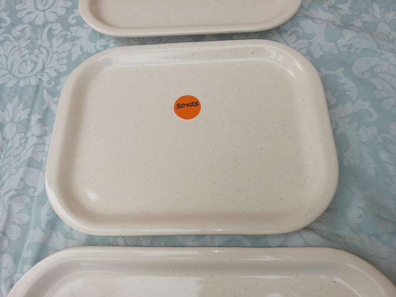 A COLLECTION OF THREE STONEWARE SERVING PLATTERS SOLD AS IS
