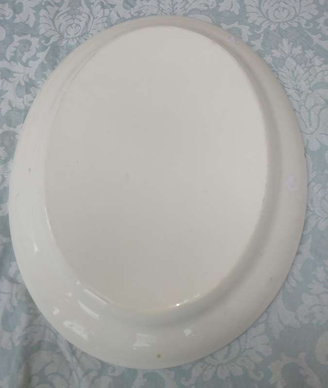 AN ART DECOR OVAL PORCELAIN PLATTER SOLD AS IS