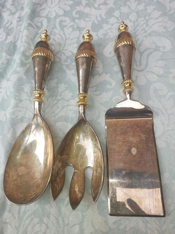 A SET OF ART DECOR STAINLESS STEEL AND BRASS SERVING CUTLERY
