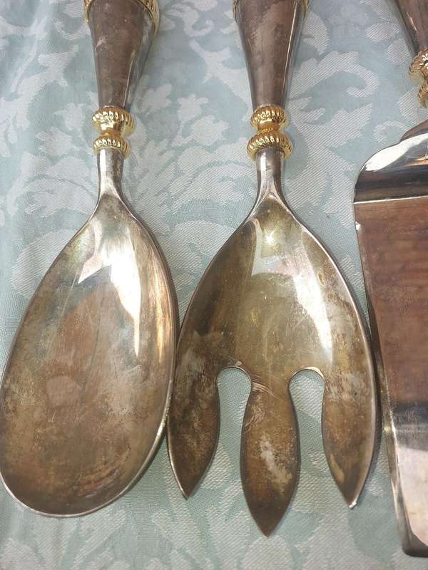 A SET OF ART DECOR STAINLESS STEEL AND BRASS SERVING CUTLERY
