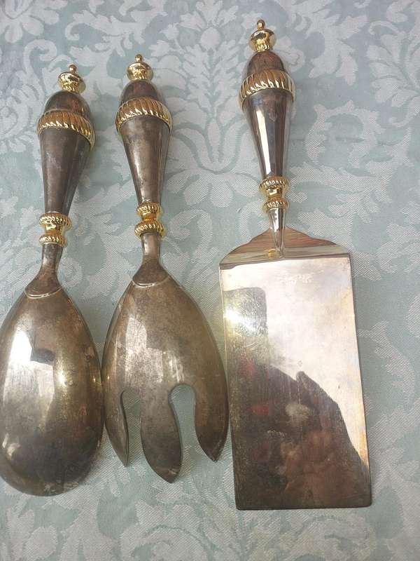 A SET OF ART DECOR STAINLESS STEEL AND BRASS SERVING CUTLERY