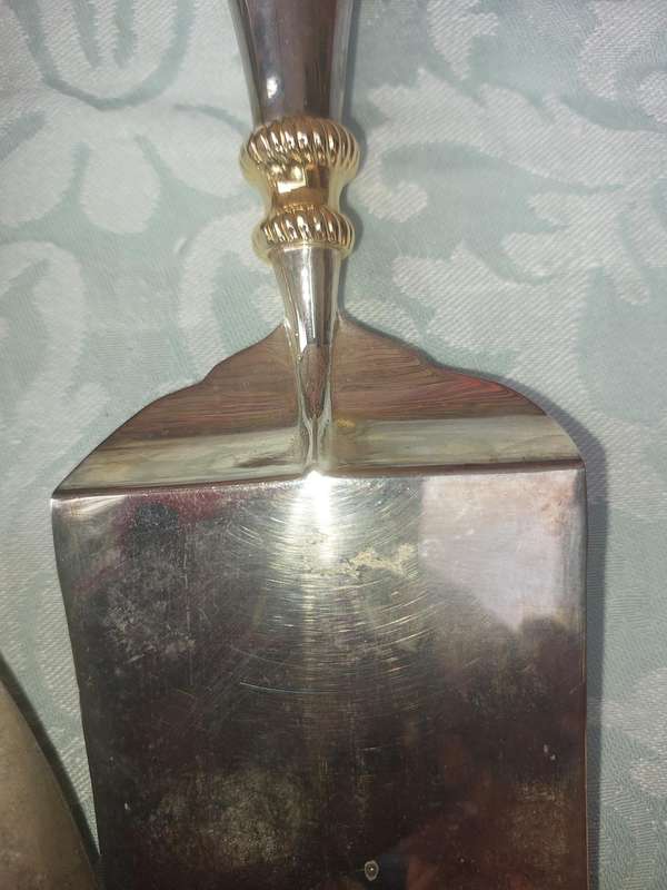 A SET OF ART DECOR STAINLESS STEEL AND BRASS SERVING CUTLERY