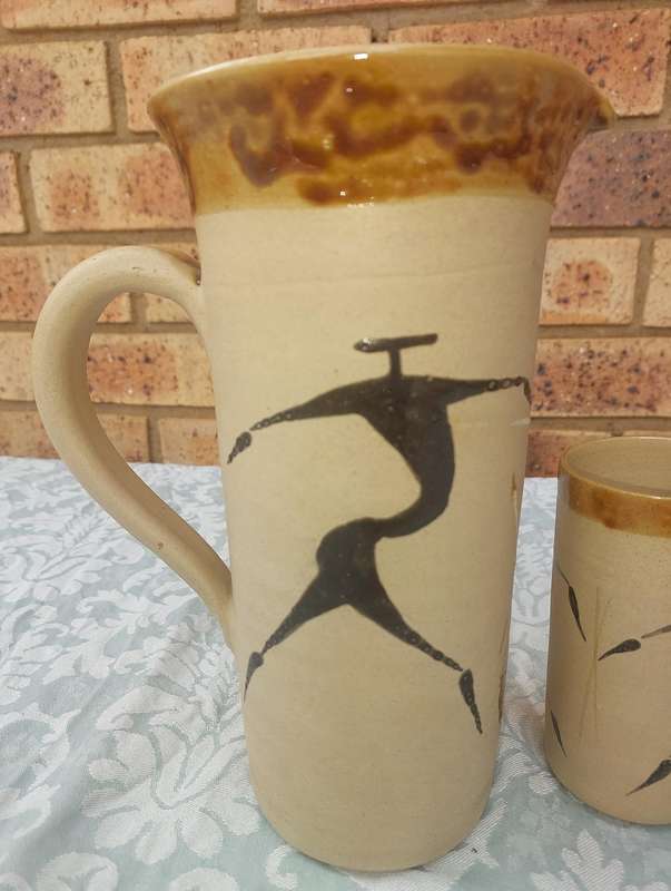 A VINTAGE SET WATER JUG AND FIVE TUMBLERS CERAMICA BY TI POTTERIES WITH AFRICAN DRAWINGS SOLD AS IS