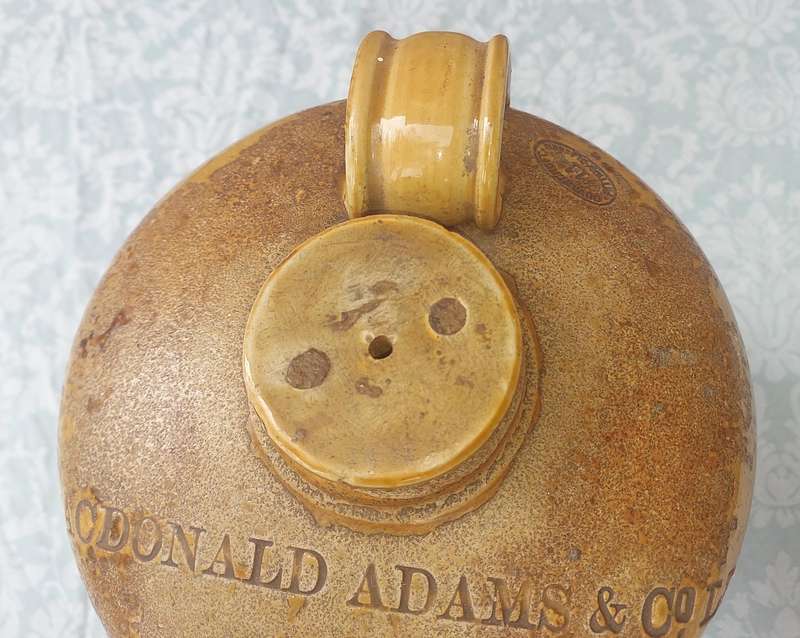 AN ANTIQUE MACDONALD ADAMS & CO LTD GIN CERAMIC JAR WITH A SCREW ON LID NO11  SOLD AS IS