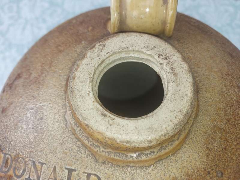 AN ANTIQUE MACDONALD ADAMS & CO LTD GIN CERAMIC JAR WITH A SCREW ON LID NO11  SOLD AS IS