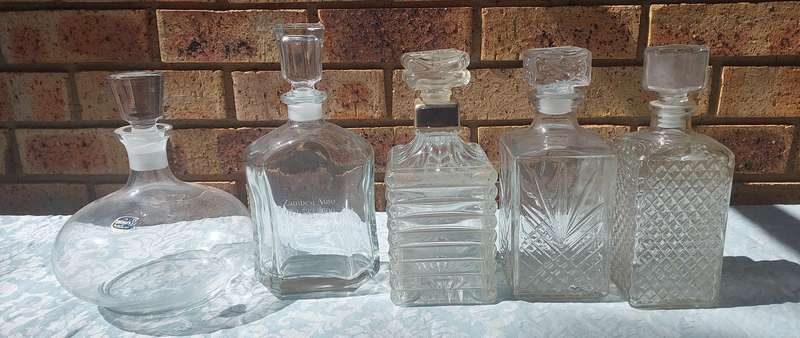 A VINTAGE COLLECTION GLASS DECANTERS FOR THE GENTLEMENS BAR SOLD AS IS