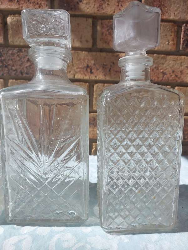A VINTAGE COLLECTION GLASS DECANTERS FOR THE GENTLEMENS BAR SOLD AS IS