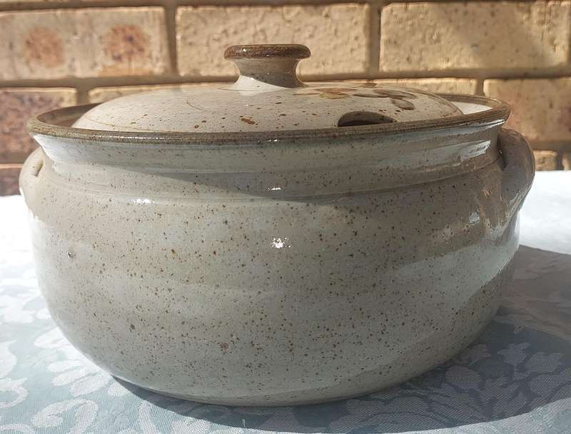 A VINTAGE BAKED CERAMIC SOUP TUREEN SOLD AS IS