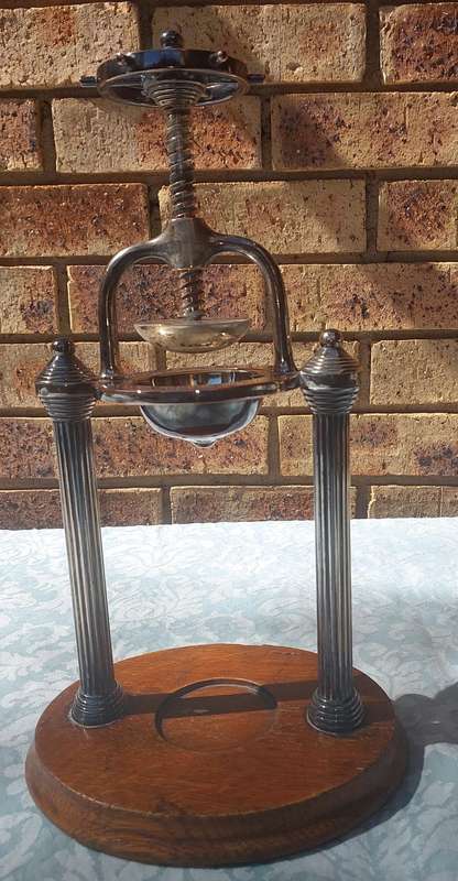 A VINTAGE FRENCH DUCK AND LOBSTER PRESS SILVER PLATED WITH WOODEN BASE SOLD AS IS