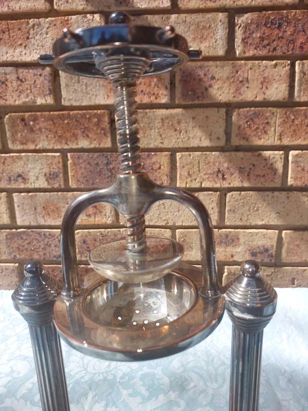 A VINTAGE FRENCH DUCK AND LOBSTER PRESS SILVER PLATED WITH WOODEN BASE SOLD AS IS