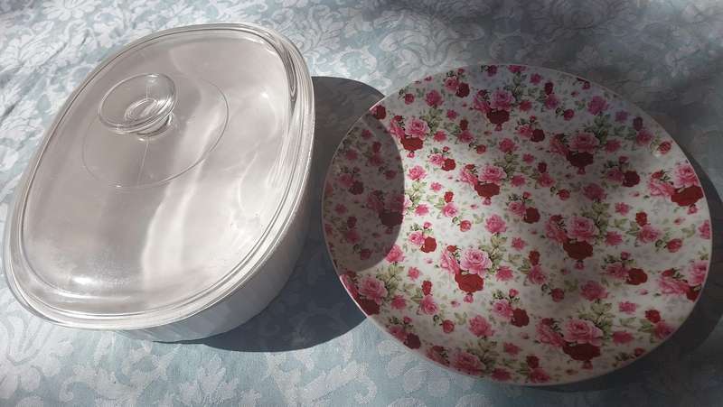 A CORNING WARE CASSEROLE AND A PORCELAIN FLORAL PLATTER SOLD AS IS