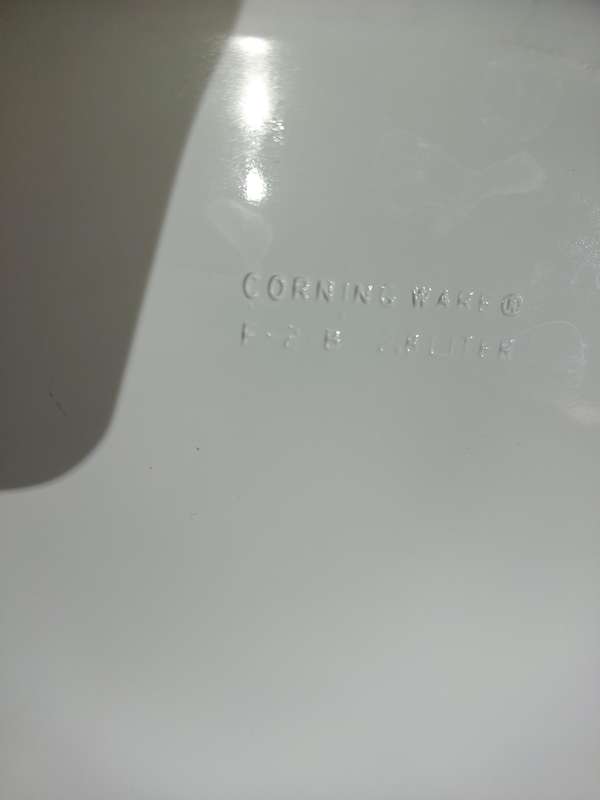 A CORNING WARE CASSEROLE AND A PORCELAIN FLORAL PLATTER SOLD AS IS