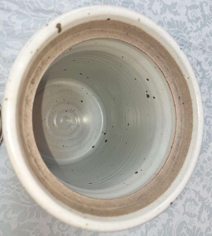 A CERAMIC POTTERY OLIVE JAR WITH A LID SOLD AS IS