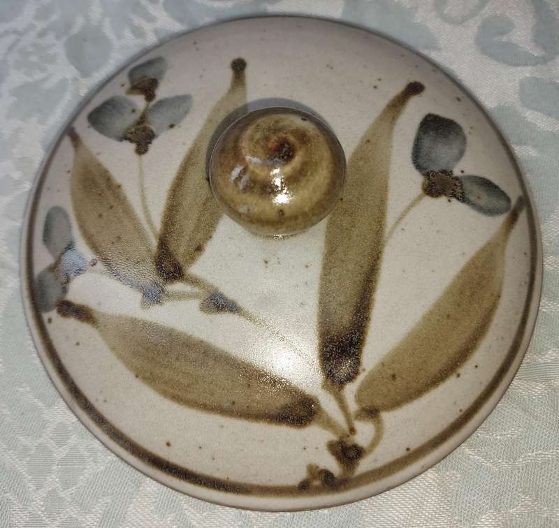 A CERAMIC POTTERY OLIVE JAR WITH A LID SOLD AS IS