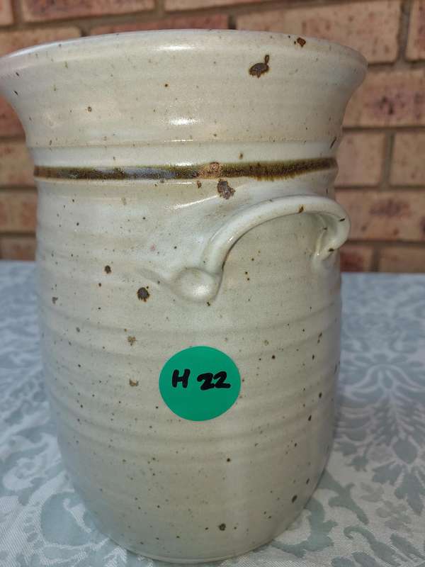 A CERAMIC POTTERY OLIVE JAR WITH A LID SOLD AS IS
